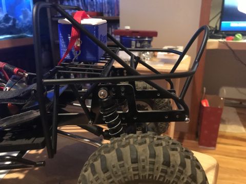 1989 Ford Bronco - Close-up of an RC rock crawler's chassis and suspension system.
