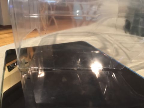 1989 Ford Bronco - A close-up, angled view of the clear plastic packaging for a vehicle part, showing a black insert beneath it. The packaging appears to be s…