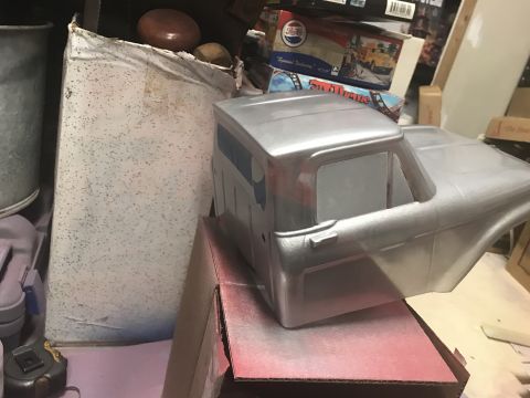 1989 Ford Bronco - A silver painted truck cab, likely a model, sits on a cardboard box. The cab is partially assembled and appears to be a custom build projec…