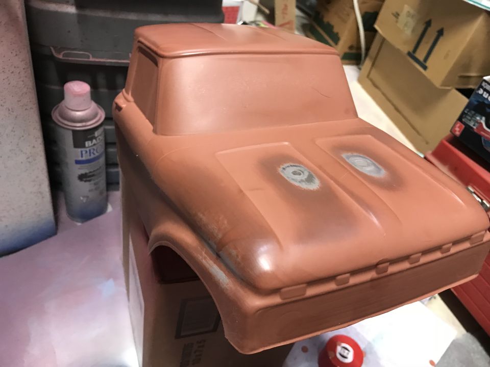 Reddish-brown plastic model truck body with sanded spots on the hood.