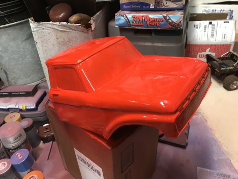 1989 Ford Bronco - A bright orange, unmounted truck body sits on a cardboard box. Several cans of spray paint are visible in the foreground.
