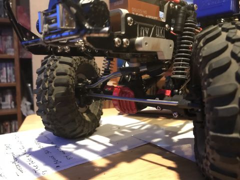 1989 Ford Bronco - Close-up view of an RC car's undercarriage, showing its suspension and drivetrain components.