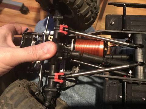 1989 Ford Bronco - Close-up of an RC car's chassis, focusing on the motor and suspension components.