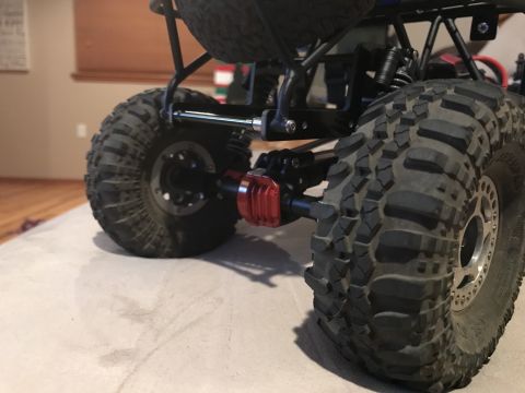 1989 Ford Bronco - The detailed rear suspension and axle of a remote control rock crawler are shown in this close-up shot.