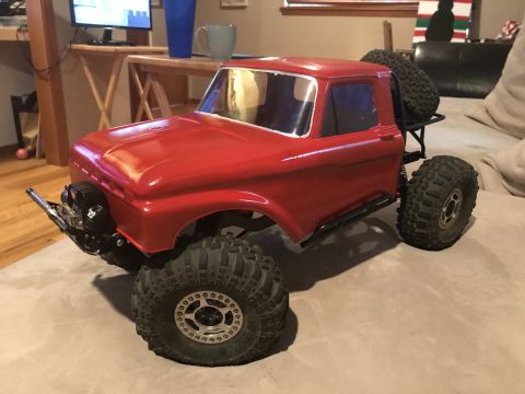 1989 Ford Bronco - This is a remote-controlled rock crawler truck with a red body and off-road tires.