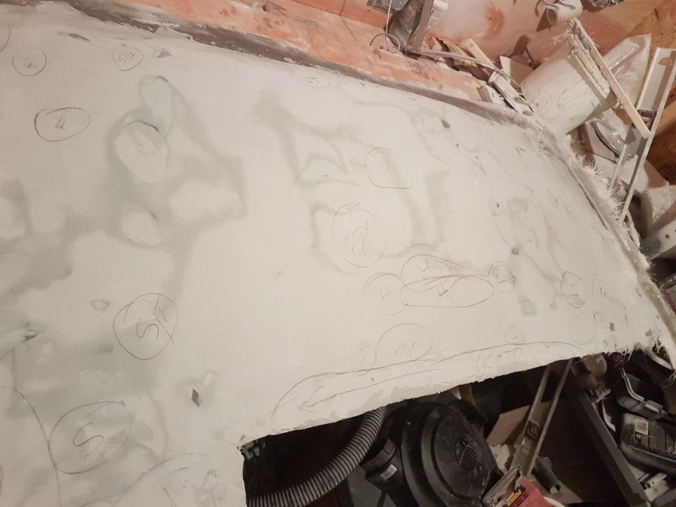 White surface with hand-drawn circles and scribbled text, possibly in a workshop.