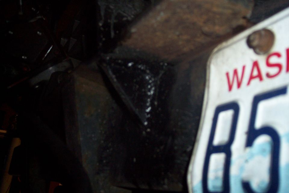 Washington license plate reading WAS 85 attached to a rusty metal frame.