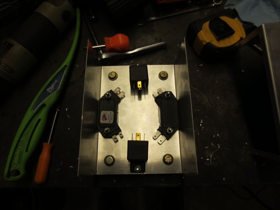 Metal plate with electronic components and tools.