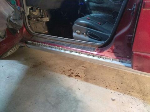 2000 Pontiac Grand Prix - A close-up interior shot of a vehicle reveals tan and red elements.