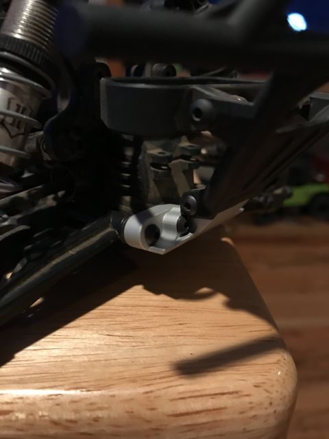 1989 Ford Bronco - A close-up view of a gray suspension component on an RC car's chassis.