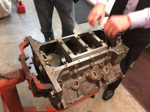 1968 Mercury Cougar - Engine block assembly in progress, with mechanics attending to the internal components.
