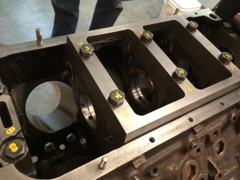 1968 Mercury Cougar - Close-up view of an engine block's crankshaft bearing journals with main bearing caps installed.