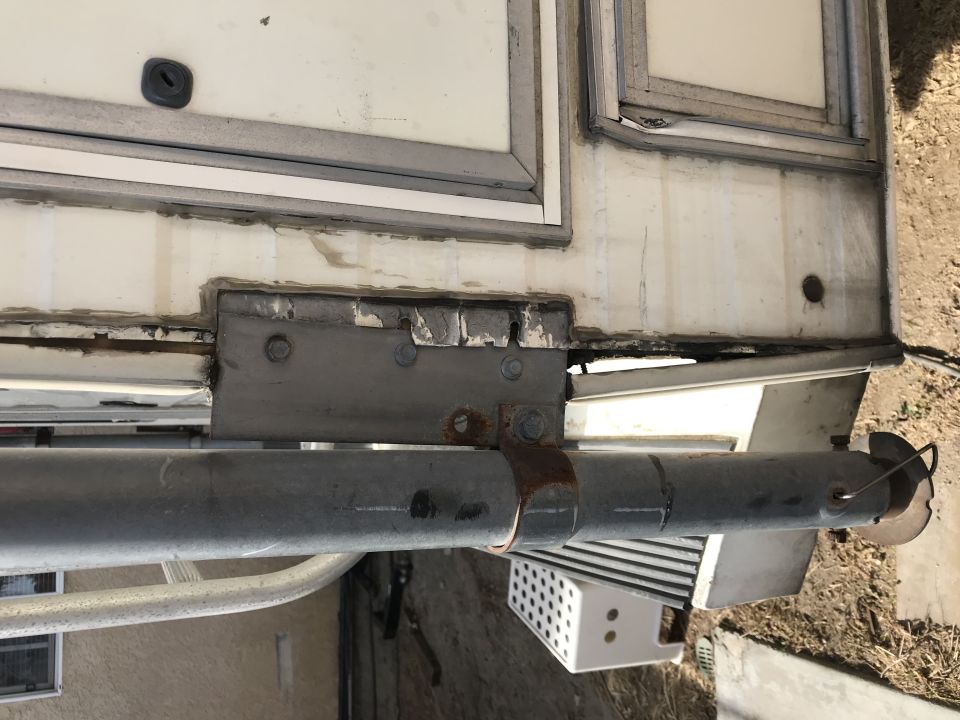 Close-up of camper body mounting bracket and roller