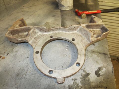 1967 Ford F-250 - A metal part rests on a workbench, with tools nearby.