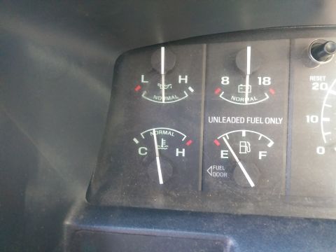 1996 Ford Bronco - Close-up of vehicle dashboard gauges including fuel, oil, and temperature indicators.