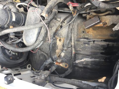 1996 Ford Bronco - Close-up view of the engine bay, highlighting the dual battery setup and associated wiring.