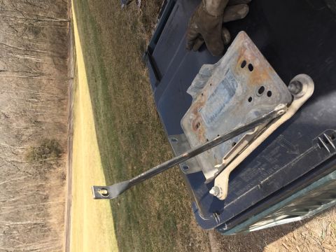 1996 Ford Bronco - A metal bracket for a dual battery setup is shown, with visible rust and mounting holes.