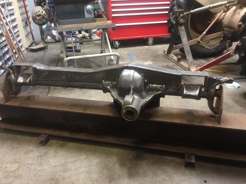 1979 Ford Bronco - Rear axle assembly shown in a workshop setting, resting on I-beams.