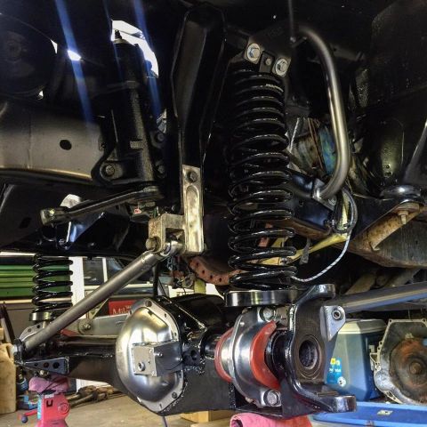 1979 Ford Bronco - Underside view of a vehicle's suspension and drivetrain, showing heavy-duty components and modifications.