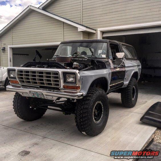 Lifted 1979 Ford Bronco, front 3/4 view, hood open, showing engine