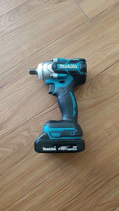 1989 Ford Bronco - A Makita 18V impact wrench rests on a wooden floor.