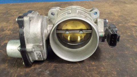 2005 Mercury Grand Marquis - A close-up view of a vehicle's throttle body, showing internal components and electronic connections.