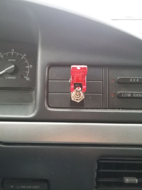 1993 Ford Bronco - Interior view of a 1993 Ford Bronco dashboard, showing a red toggle switch installed on the air vents.