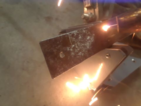 1985 Ford Bronco - Metal parts are being welded together, with bright sparks illuminating the scene.