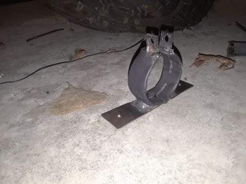 1985 Ford Bronco - A fabricated exhaust hanger, likely for a vehicle, is shown mounted on a metal plate.
