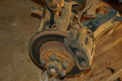 1998 Ford Ranger - Close-up view of a vehicle's front brake assembly, including the rotor and caliper, with a Supermotors.net watermark.