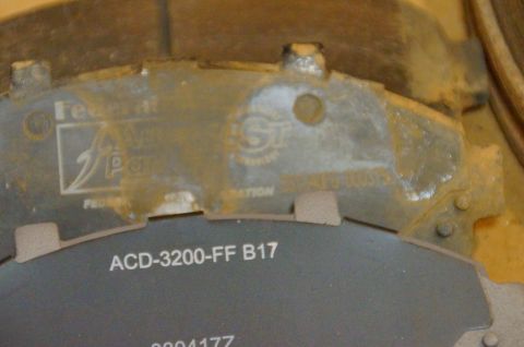 1998 Ford Ranger - A close-up view of a brake pad shows part numbers and manufacturer markings.