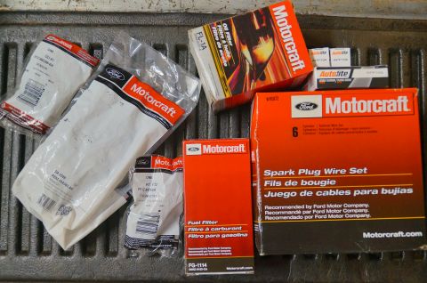 1998 Ford Ranger - Various Ford Motorcraft and Autolite engine parts are laid out on a textured surface.