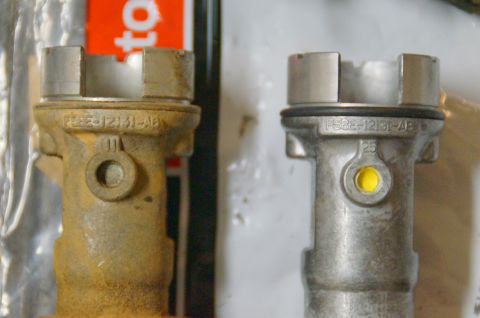 1998 Ford Ranger - Comparing a rusty old brake master cylinder reservoir with a new one, both marked F58E-12131-AB.
