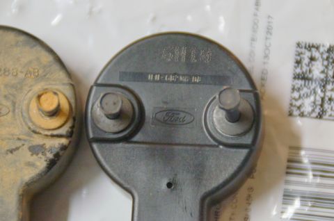 1998 Ford Ranger - Close-up of two Ford engine components, one showing the Ford emblem and part identification.