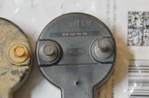 1998 Ford Ranger - Close-up of a Ford branded part, possibly from an engine component, with visible part numbers.