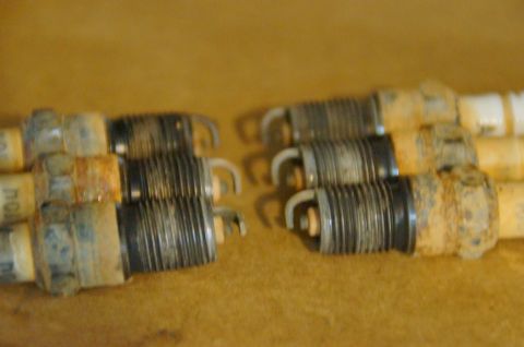 1998 Ford Ranger - Six used spark plugs show signs of wear and corrosion.