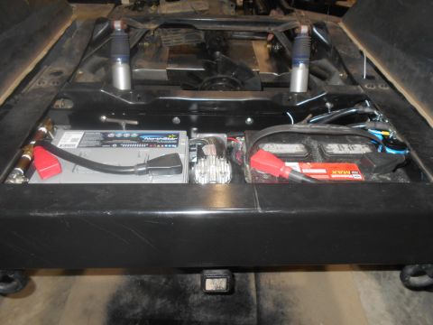 1992 Ford Bronco - Underside view of a vehicle chassis showing dual battery setup and suspension components.