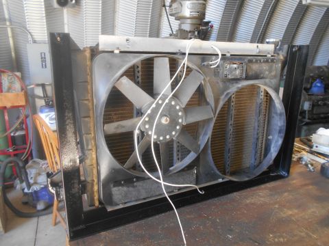 1992 Ford Bronco - Radiator and fan assembly shown on a workbench, likely for repair or replacement.
