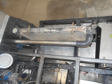 1992 Ford Bronco - Close-up view of the radiator and exhaust system within a vehicle's frame, showing engine components.