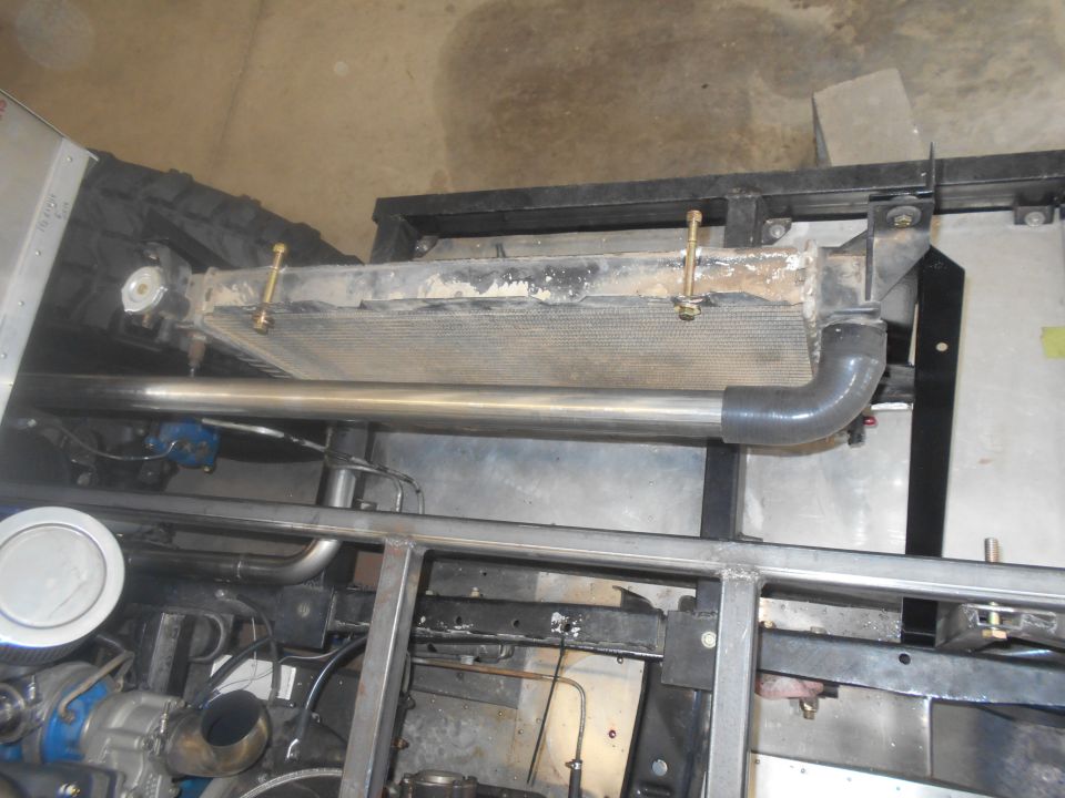 Radiator and exhaust pipe in a vehicle chassis