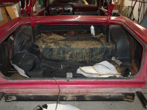 1967 Ford Galaxie - The trunk of a red 1967 Ford Galaxie convertible shows signs of wear and tear, possibly, a recent repair attempt.