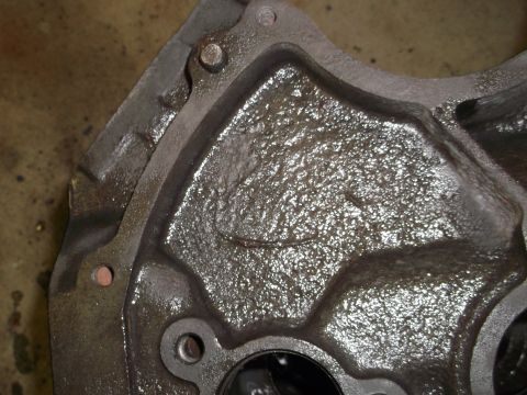 1969 Ford Mustang - This is a close-up view of a cast iron engine block, showing its textured surface and oil residue. The registry claims it is a 1969 Ford Mu…