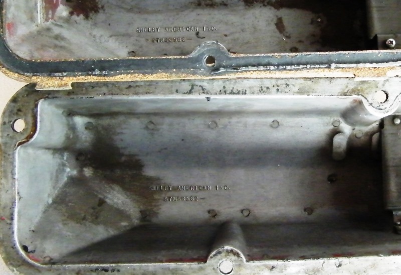 Two Shelby American Inc. metal parts with stamped text.