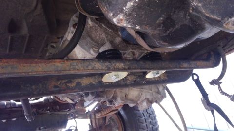 1988 Ford Bronco - transmission crossmemeber relocated for the E4OD and modified a universal body mount bushing to to use as a transmission mount