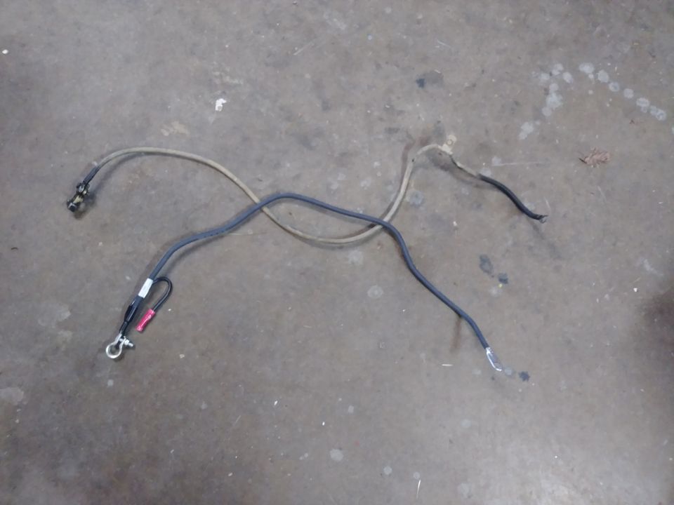 Automotive battery cables on a concrete floor.