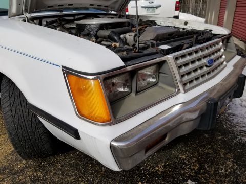 2001 Ford Crown Victoria - Photograph of a white Ford front end with open hood, not a technical document.