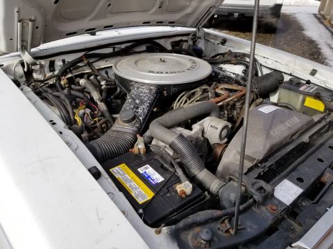 2001 Ford Crown Victoria - Photograph of an engine bay showing air cleaner and battery, not a technical document.
