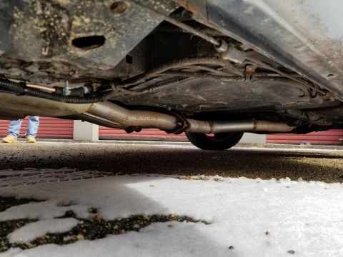 2001 Ford Crown Victoria - Photograph of a vehicle underbody exhaust system and floor pan; not a technical document.