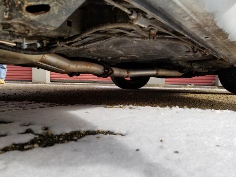 2001 Ford Crown Victoria - Photograph of a vehicle underbody exhaust pipe and muffler; not a technical document.