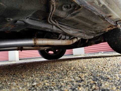2001 Ford Crown Victoria - Photograph of a vehicle underbody exhaust and suspension area; not a technical document.